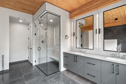 Bathroom with a glass shower stall and a large mirror