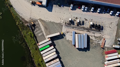 Aerial View Logistics Park With Warehouses Halifax Nova Scotia Canada. Drone Footage Showing Large Industrial Hub With Semi Trucks And Cargo Trailers Parked At Loading Ramps During Sunset In Halifax.