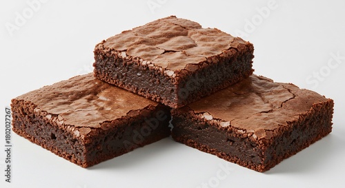 柔らかな光に照らされた濃厚でしっとりとしたチョコレートブラウニー三つが美しく積み重なる甘いデザート. AI Generated