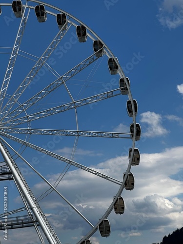 Photography A quiet moment beneath a Ferris wheel arching into the sky