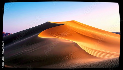 Fototapeta Naklejka Na Ścianę i Meble -  Vast golden sand dunes are illuminated by the warm glow of sunrise, casting long shadows and highlighting the undulating curves of the desert landscape.