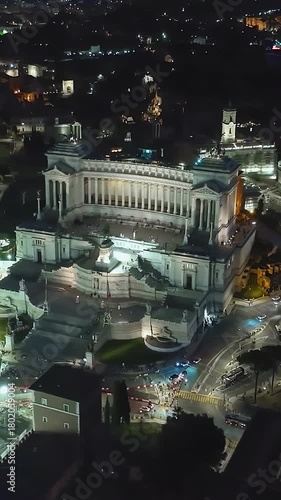  Establishing shot drone flying of historical monument to Vittorio Emanuele II in Rome on Venice Square at night. Downtown Rome, Italy