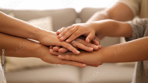 Wallpaper Mural A close-up shot shows a family's hands stacked together, fingers interlaced. A ring is visible Torontodigital.ca