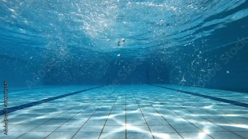 underwater view of a swimming pool with bubbles for hotel and resort advertisements, spa brochures, water safety awareness, and summer backgrounds