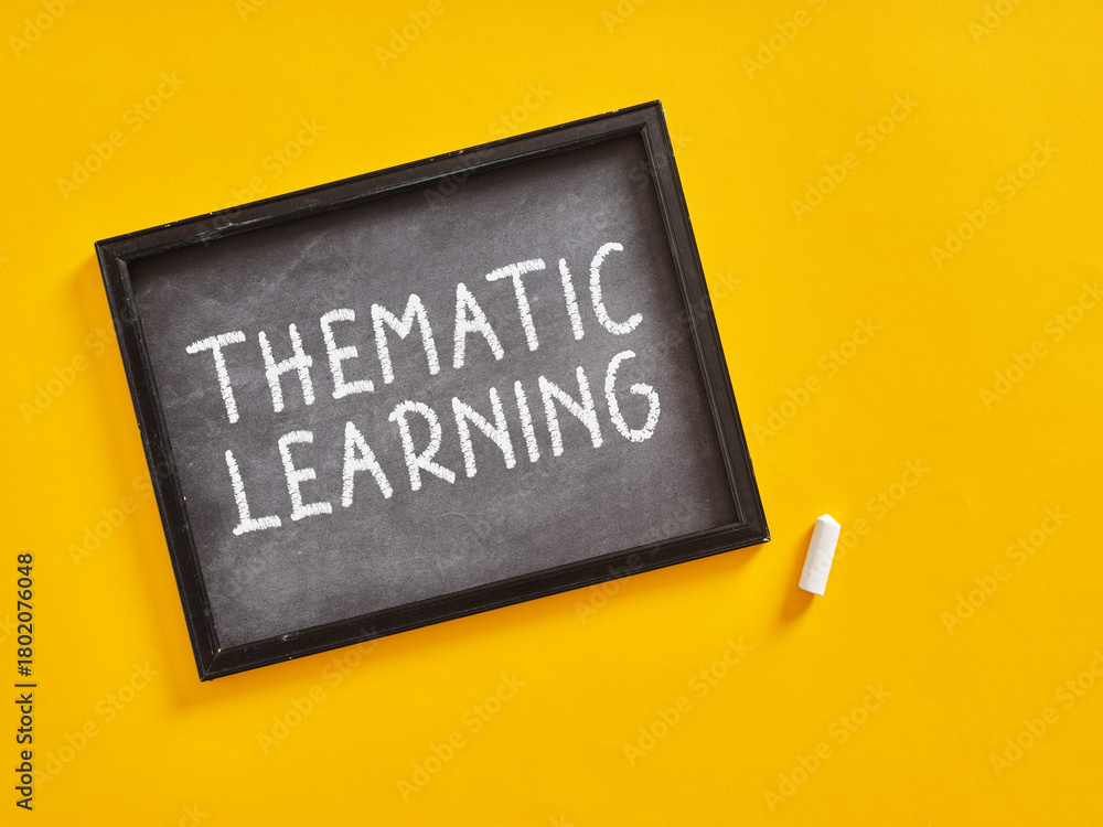 Blackboard with thematic learning written on it promoting thematic learning techniques