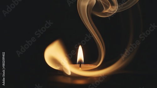 Warm glowing candlelight with rising smoke on a dark background