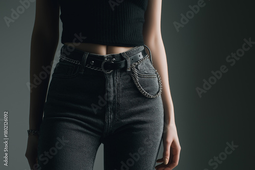 Stylish woman in high-rise jeans and crop top minimalist studio portrait fashion