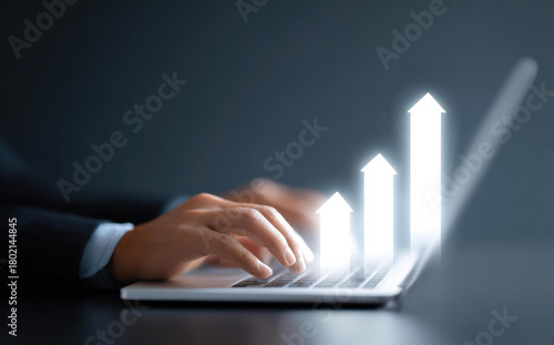 Businessman analyzing business growth and success on laptop. glowing chart shows finance data, concept of technology investment and positive future progress