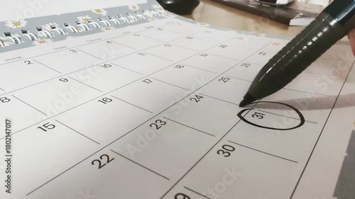 Person circling event date reminder on month calendar - 31th day in month calculator	
