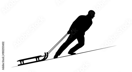 Man pulling sled up snowy hill in silhouette  