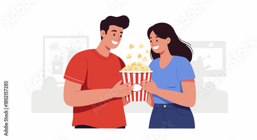 Happy young couple sharing popcorn at the cinema, enjoying a movie date night with smiles and leisure.