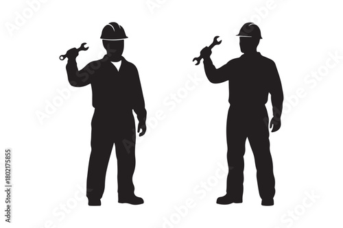 Silhouettes of two construction workers holding wrenches