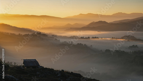 Golden Sunrise Over Misty Mountain Layers and Peaceful Valley Landscape in Early Morning Light