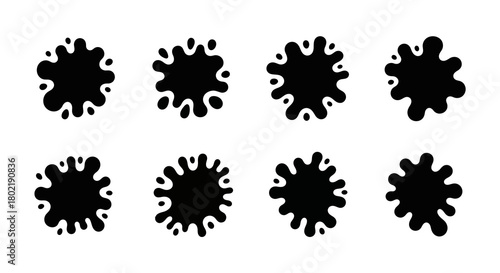 Set of black ink splatter shapes on white background for creative designs