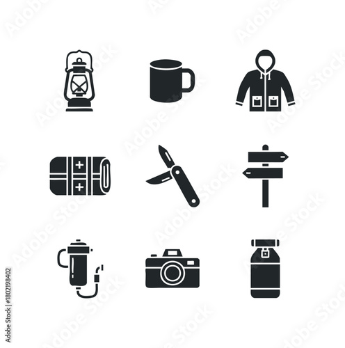 Outdoor gear collection with lantern, mug, jacket, first aid kit