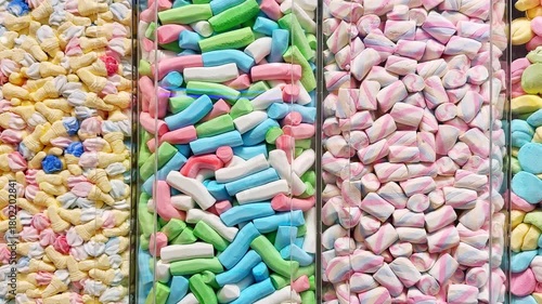 Colorful candies displayed in a sweet shop, neatly arranged in transparent containers. Bright pastel sweets symbolizing sugar, confectionery, and sugar-free treat concepts.