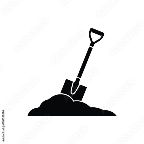 Black silhouette of a shovel digging into a pile of dirt