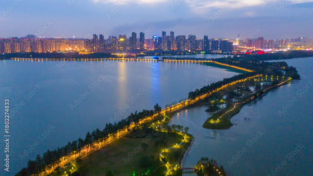 Fototapeta premium East Greenway Lake and City Skyline at Night - Aerial View