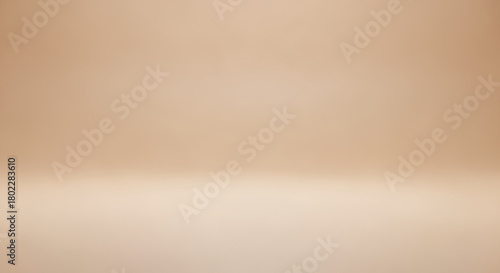 A plain beige studio backdrop with a subtle gradient effect