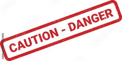 A rectangular red caution danger rubber stamp with textured grunge marks on a clean white surface