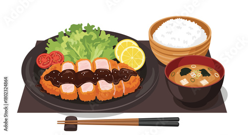 A beautifully presented Japanese tonkatsu set meal with white rice, miso soup, salad, and lemon wedges, ready to enjoy.