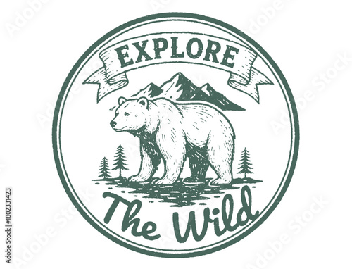 Vintage circular badge featuring a bear, mountains, and pine trees with "Explore The Wild" text.