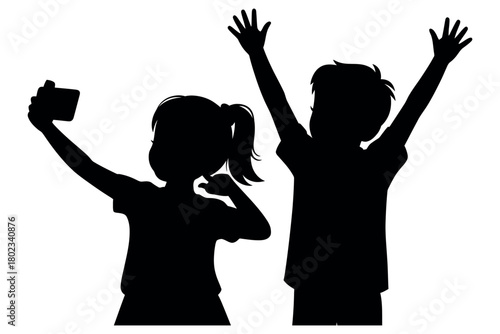 Two children joyfully pose for a selfie together with raised arms.