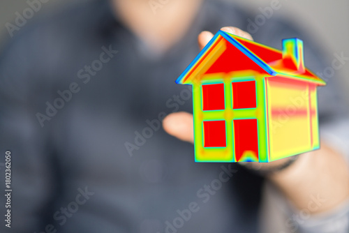 Hands holding model house i...