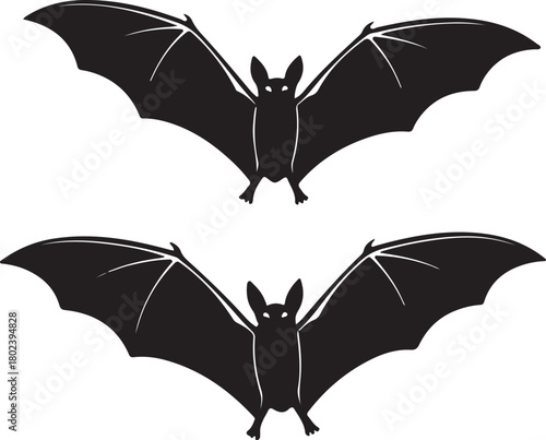 Two silhouetted black bats with outstretched wings in flight against a white background creating a spooky and mysterious halloween or gothic aesthetic