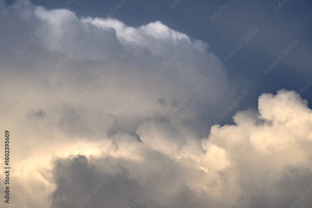 Fototapeta premium An evening dramatic golden hour sky background with clouds and soft sun rays breaking through.