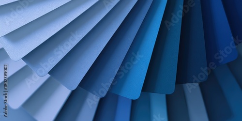 Colorful display of paint samples in various shades of blue arranged in a fan pattern at a design studio