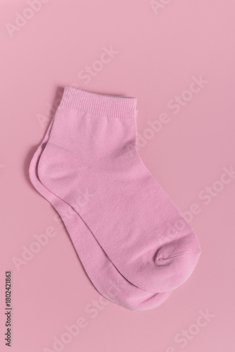 Pink children socks isolated on pink background. Flat lay