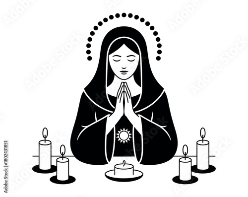 A woman in traditional religious attire prays with hands clasped surrounded by lit candles.