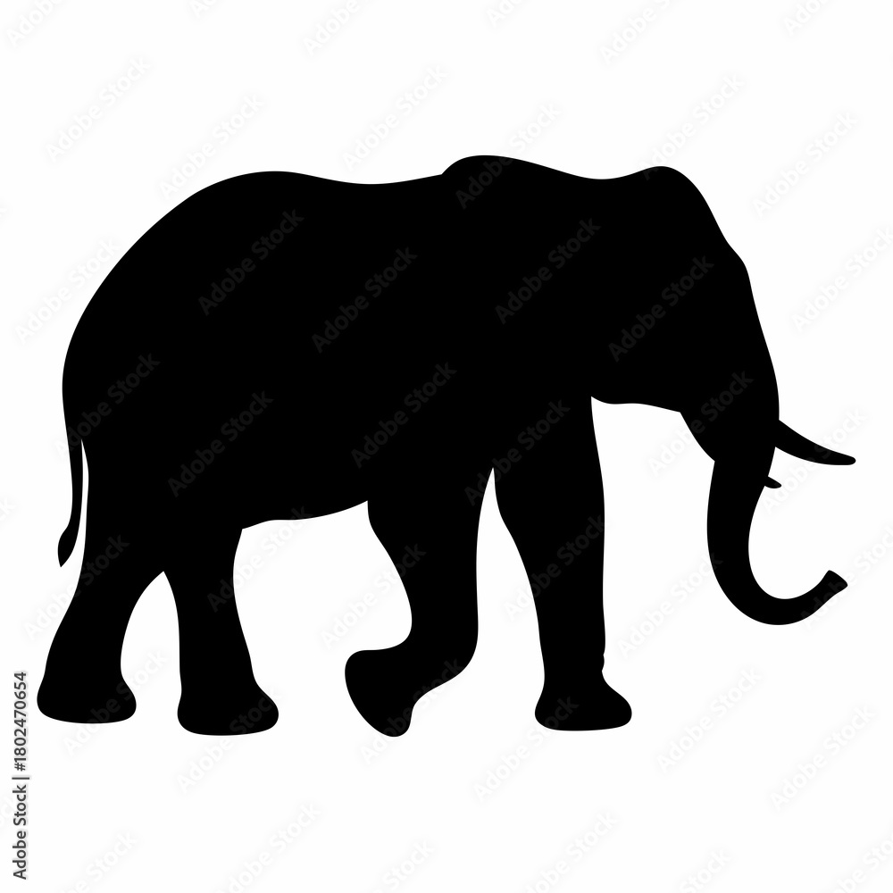 Fototapeta premium Silhouette of an African Elephant Walking Slowly Across the Plain