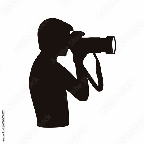 Silhouette of a photographer taking a picture with a professional camera