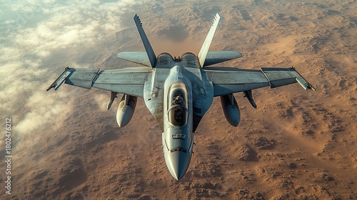 Military jet soaring above desert landscape during clear daytime sky