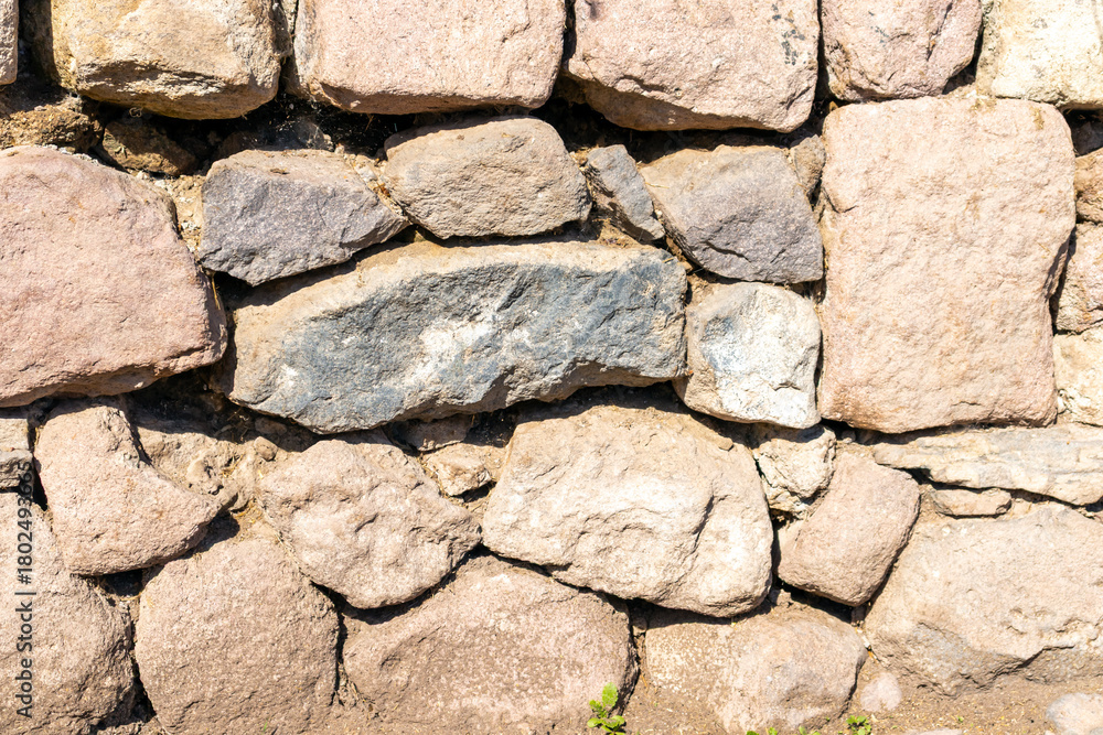 Obraz premium A natural stone masonry wall, background.