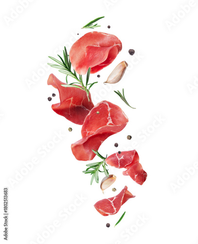Slices of fresh prosciutto ham with rosemary and garlic cloves isolated on transparent background