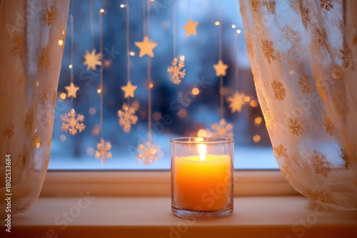 Candlelit window with glowing orange candle, delicate snowflakes and stars hanging, creating a warm and cozy atmosphere for winter evenings with copy space