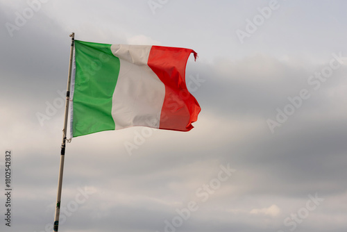 Flag of Italy against the blue sky.