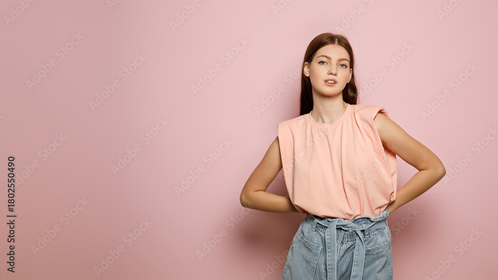 Obraz premium Fashion model poses confidently in a stylish outfit against a pastel background