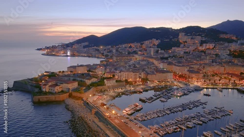 sunset over france coastal town with boats, scenic view of ancient castle and busy marina at dusk. Ajaccio