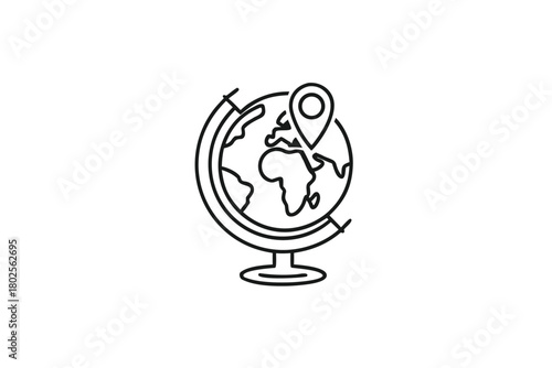Desk globe with a pin marks a specific spot in outline