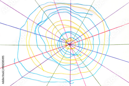 Colorful knitting threads in a shape of a spider web