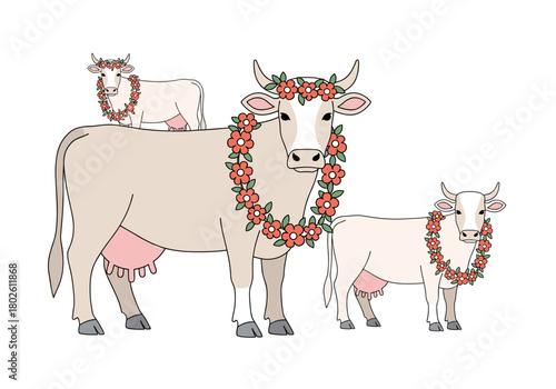 Three decorated cows with floral wreaths standing together  