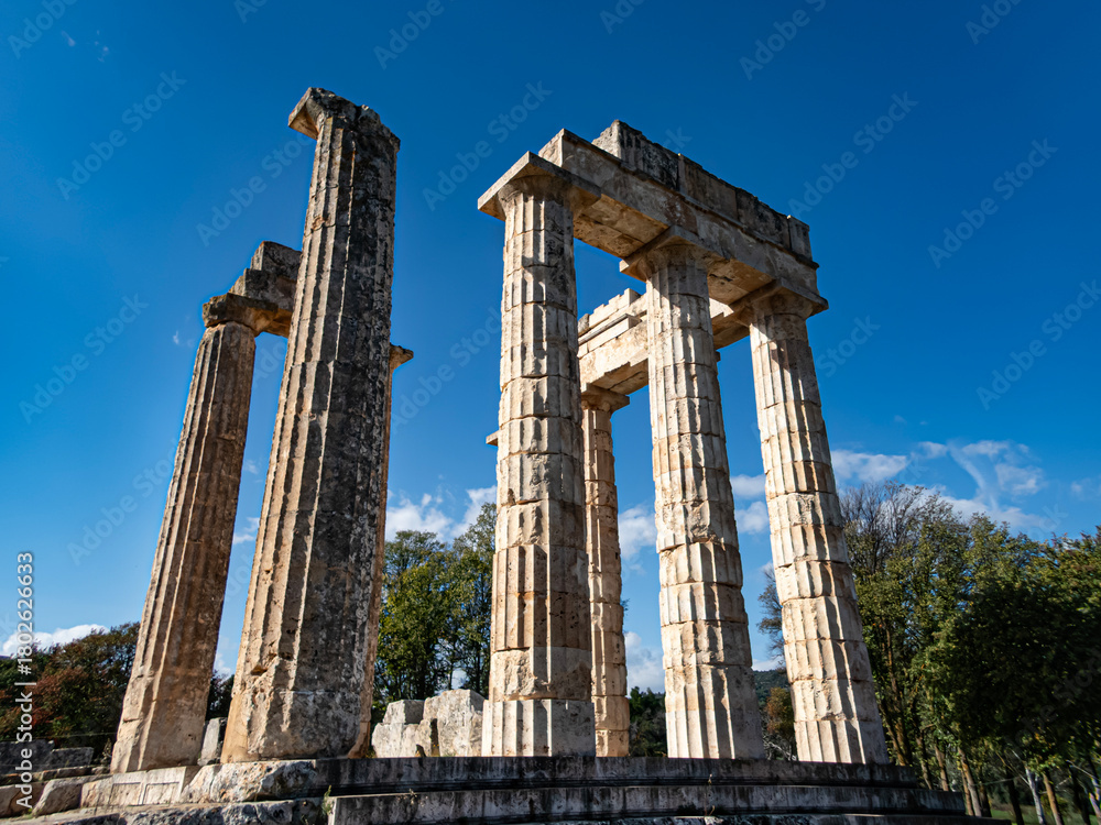 Naklejka premium The temple of the Nemean Zeus was built around 330 B.C. to serve the needs of the festival and the games. Three of the ancient culumns remain standing until today.
