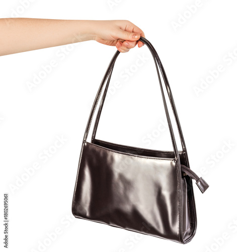 Isolated photo of female hand holding brown leather purse or bag with copy space on white background. Side view.