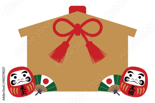 A wooden ema plaque adorned with a red ribbon and tassels is displayed with two daruma dolls and two small fans, representing Japanese culture and traditions.
