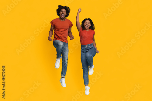 Εκτύπωση καμβά Two young adults jump joyfully in mid-air, expressing excitement and happiness