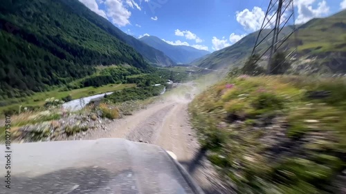 Wallpaper Mural POV Dirt road in the mountains. Off-road trip through the Caucasus. Green slopes, blue skies, river and mountain peaks Torontodigital.ca